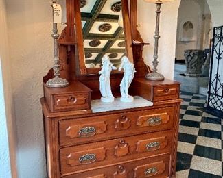 Marble top dresser with two jewelry drawers and tilt mirror. Measures 70”h x 40”w x 17”d.