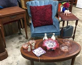 Blue accent chair, oval coffee table, small side table, and décor 
