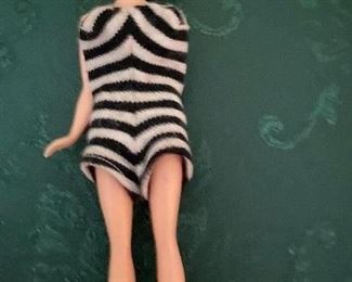 WHAT A FIND..Bild Lili 7.5 Inches Doll. She is wearing a regular Vintage B/W Striped Swimsuit..she only has 1 arm. Hair is Blonde Ponytail. Hong Kong, British Patent 