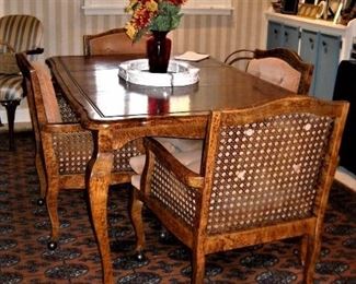 DINING / GAME TABLE WITH 4 CANE BACK CHAIRS ON CASTERS