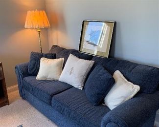 Blue sofa, brass floor lamps