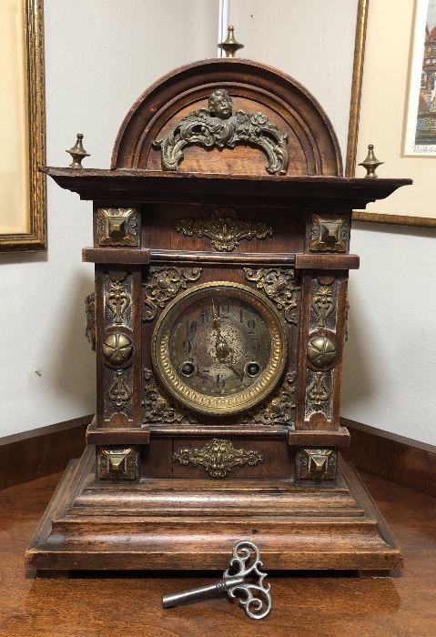 Antique mantel clock with ornate brass accents