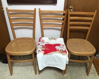 Set of 4 cane seat chairs (4th chair not shown - it has a hole in the seat) + vintage screen print Xmas tablecloth