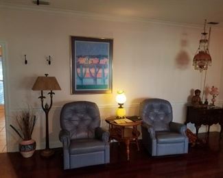 Pair of blue Lazy boy leather recliners, parrot floor lamp, antique hanging crystal pink to clear lamp. Buddha statue, pottery.