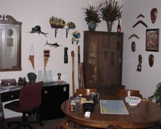 Office full of eclectic art, carvings, masks, fish and more. Nice table and captain chairs set. Corner desk, very "Beachy" looking Ethan Allen