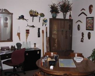 Office full of eclectic art, carvings, masks, fish and more. Nice table and captain chairs set. Corner desk, very "Beachy" looking Ethan Allen 