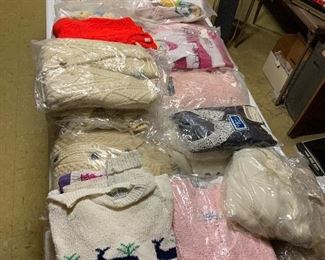Tons of brand new sweaters still in the plastic!