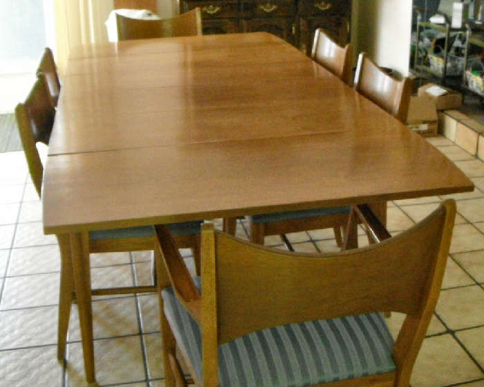 Danish Mid Century Modern.  8'1" X 3'4" with all three leaves in.  8 Chairs.