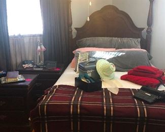 Fancy poster bed with lamp on the left there with glass lily shades. 