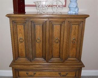 Bedroom #1-Main Floor:  A HENREDON chest with two folding doors and two lower drawers measures 40" wide x 19" deep x 50" tall.  The next photo shows the doors open.  The framed poster, lamp, wire bicycle planter and blue bunny are also for sale.