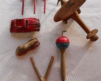 "Smalls" Area-In a Case:  A few wooden Tinker toys have been bagged as one unit; but the vintage metal cars; sling shot (as is); vintage wooden souvenir plane; and musical toy are all priced separately.