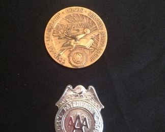 "Smalls Area"-In a case:  From top to bottom:  Token: "Keep Me & Never Go Broke" Lucky 1948 Wheat Penny - Saline Motor Co., Harrisburg, IL; Medallion:  American Legion School Award; and a vintage 1960s AAA Patrolman School Safety Patrol Badge.