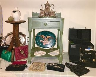Antique plant stand, painted stand/table with drawer, Singer Featherweight sewing machine, Rogers Bros silver plate set and platter, antique whisk broom & holder, vintage & modern purses