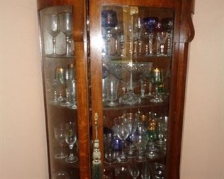 vintage china cabinet full of glass ware