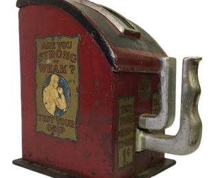 1920s Penny Arcade Grip Strength Test Machine made by Gottlieb. It is made of cast iron and steel and features decals on both sides with strongman graphics that read “Are You Strong Or Weak”-“Test Your Grip”