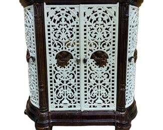 Antique French Enamel cast iron stove cover shaped oval form with neoclassical decoration in brown and white enamel, four open work doors and top with medallions of putti warming their hands at fires, acanthus leaves on the supports and scrolled feet, tin back, top also lifts up. Measures 33 1/2 “h x 32” x 13 1/2”