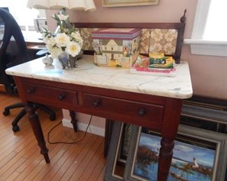 Marble top, back splash with tile on this two drawer table.