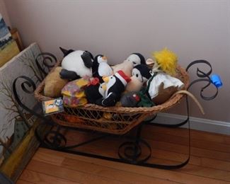 Sled decor with lots of stuffed animals.
