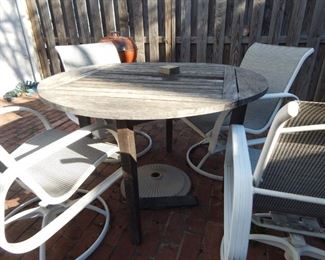 Outdoor furniture. Wooden table and four arm chairs.