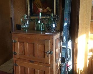 Antique ice box, snow skis, vintage wine bottles