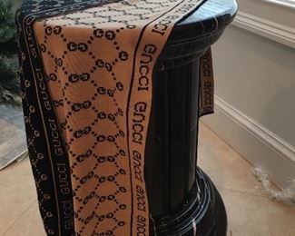 Gucci Scarf posed on one of a pair of pedestals