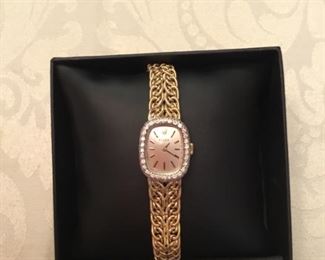 14kt yellow gold rope bracelet a Rolex ladies & diamond bezel.