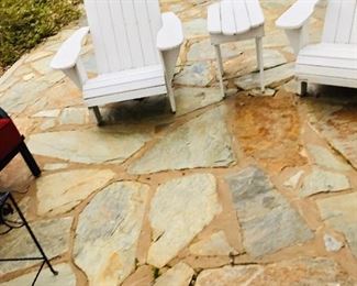 Two white Adirondack chairs and matching table