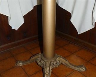 The metal base of the round table with the Pfaltzgraff dish set.