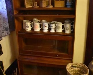 antique 4 Stack Barrister with Primitive Butter Molds on Top Shelf and "College" Stein Mugs on 2nd Shelf