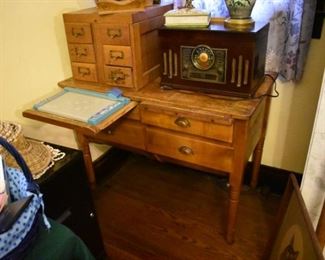 Antique Bakers Table with 4 Drawers/Bins and 2 Pull Out  Rolling/Cutting Boards. Sitting atop is an antique Oak 6 Drawer Filing Cabinet and a reproduction Radio/Vinyl Record Player 