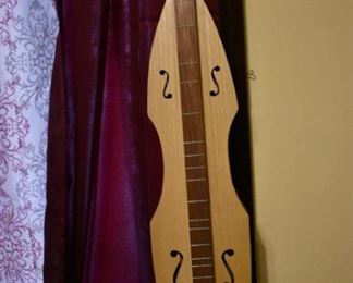 Hand made by Dr. George Richard Buchanan, who also published a book on the making of fine dulcimers, This is a fine example of his work, a Fiddle Dulcimer made of Walnut and Copper.