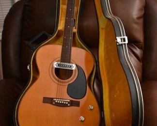 Vintage Fame Acoustic-Electric Guitar 747 Chet Atkins MIJ Japan 1970's w/Hard Shell Dean Case!
designed by Chet Atkins for the program, Famous American Musicians & Educators, as a 747 model made in Japan in the 1970s.  "Natural finish, rosewood back & sides, spruce top, bound mahogany neck with rosewood fingerboard & pearl dot inlays, individual chrome tuners, adjustable rosewood bridge, black pickguard, factory soundhole pickup with Volume & Tone controls." This Guitar is like "Show Room New!"