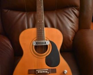 Vintage Fame Acoustic-Electric Guitar 747 Chet Atkins MIJ Japan 1970's w/Hard Shell Dean Case!
designed by Chet Atkins for the program, Famous American Musicians & Educators, as a 747 model made in Japan in the 1970s.  "Natural finish, rosewood back & sides, spruce top, bound mahogany neck with rosewood fingerboard & pearl dot inlays, individual chrome tuners, adjustable rosewood bridge, black pickguard, factory soundhole pickup with Volume & Tone controls." This Guitar is like "Show Room New!"