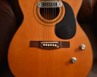 Vintage Fame Acoustic-Electric Guitar 747 Chet Atkins MIJ Japan 1970's w/Hard Shell Dean Case!
designed by Chet Atkins for the program, Famous American Musicians & Educators, as a 747 model made in Japan in the 1970s.  "Natural finish, rosewood back & sides, spruce top, bound mahogany neck with rosewood fingerboard & pearl dot inlays, individual chrome tuners, adjustable rosewood bridge, black pickguard, factory soundhole pickup with Volume & Tone controls." This Guitar is like "Show Room New!"