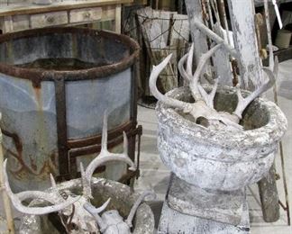 Pair of vintage concrete pedestal garden urns, Deer skulls/antlers, portion of an Old Still, old stool