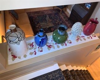 Five vases ranging in size and color. 