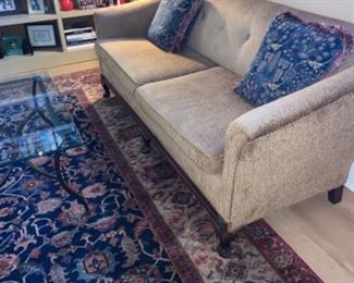 Antique Samovar rug,  loveseat sofa, and books.