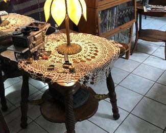 Slag lamp on heavily carved parlor table