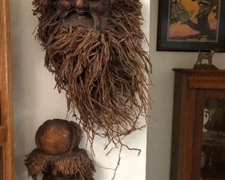 Carved tree root spirit faces