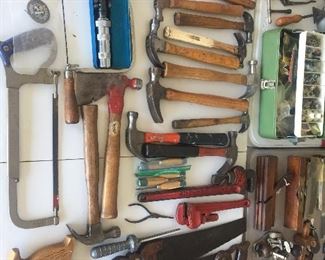 A large selection and variety of vintage hammers and saws