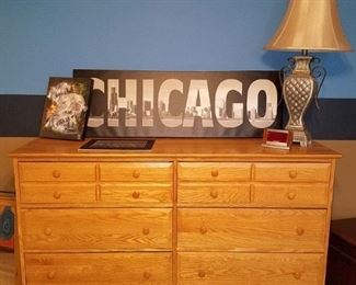 Large wood dresser. Chicago skyline and sports art. Lamp.