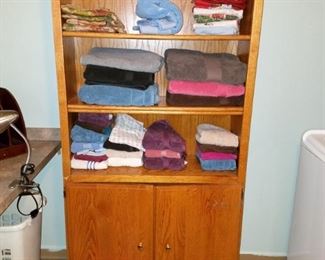 Bath linens. tall wood bookcase/cabinet