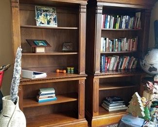 Three wood bookcases with gorgeous crown molding.