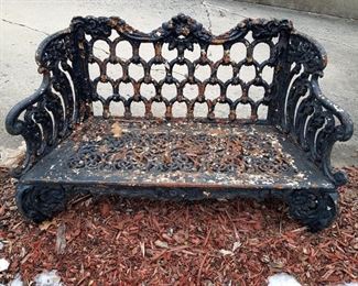 Cast metal outdoor bench (yes...it does have legs...they are sunk into the soil!)