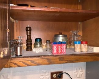 A few different assortments of kitchen items as well as a collection of salt and pepper shakers