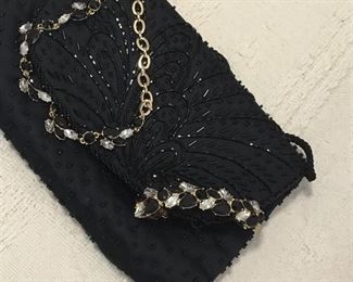 Two beautiful black with crystals Anne Kline jewelry on black beaded purse.