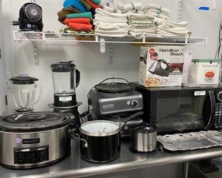 Misc. small kitchen appliances including Crockpots, blenders, a microwave & more. 
