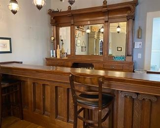 Solid oak wine bar purchased from Architectural Warehouse. Absolutely stunning piece features solid wood construction & built-in glass & bottle storage in the front bar. The backbar is also features solid wood construction, cabinet/drawer storage & mirrored panels. 
