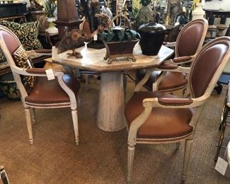 Travertine table by Roche Bobois, set of leather upholstered Louis XVI fauteuils.