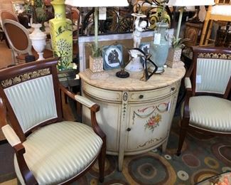 Pair of Regency style armchairs, demilune cabinet with classical painted motifs.